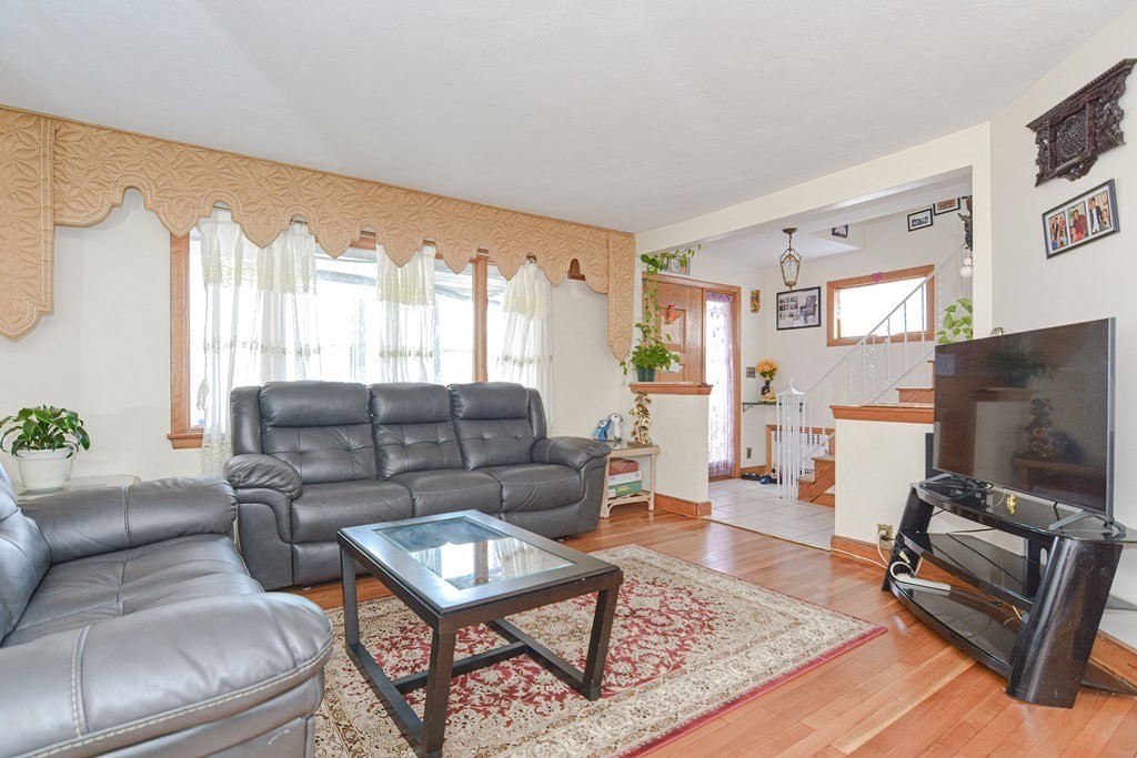 16 Rosedale Avenue Everett, MA 02149 - Photo 6 of 29 a living room with furniture a flat screen tv and a large window