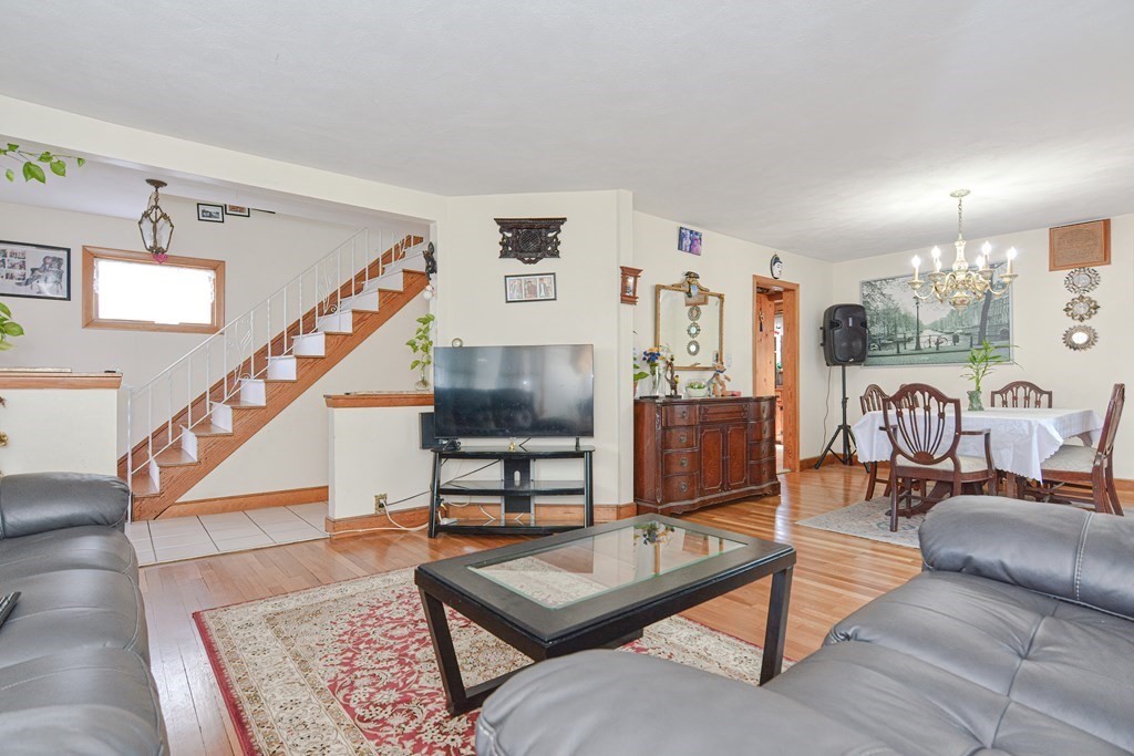 16 Rosedale Avenue Everett, MA 02149 - Photo 7 of 29 a living room with furniture a rug and a wall painting