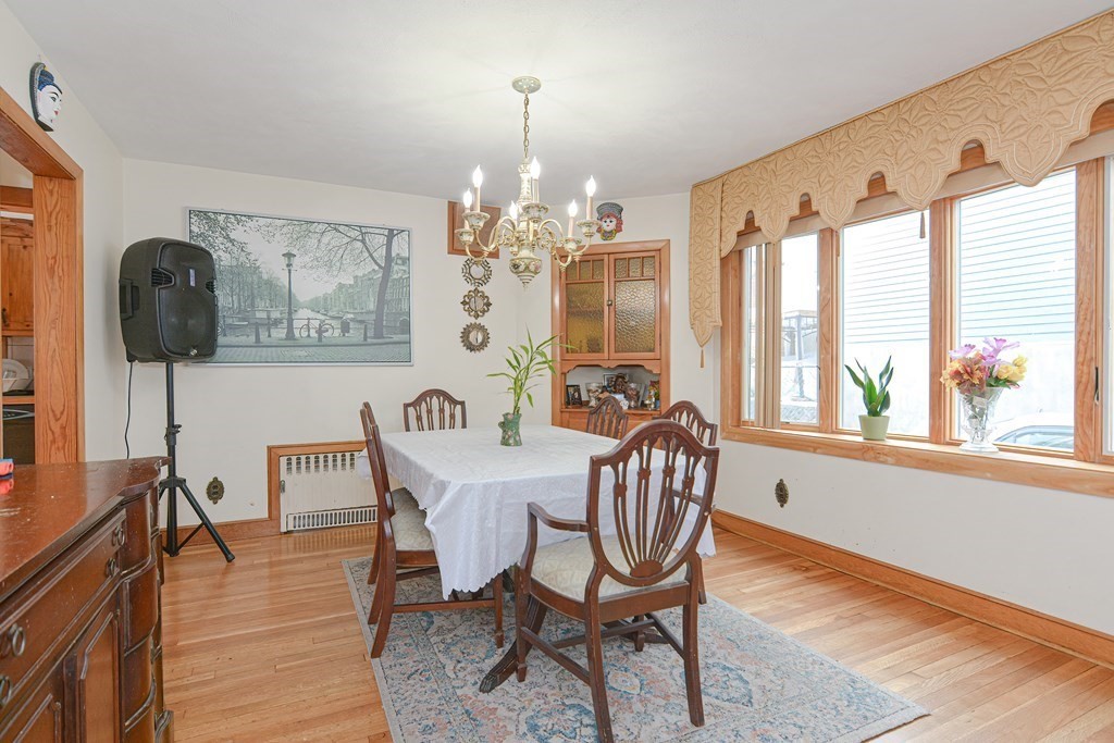 16 Rosedale Avenue Everett, MA 02149 - Photo 8 of 29 a view of a dining room with furniture a chandelier and wooden floor