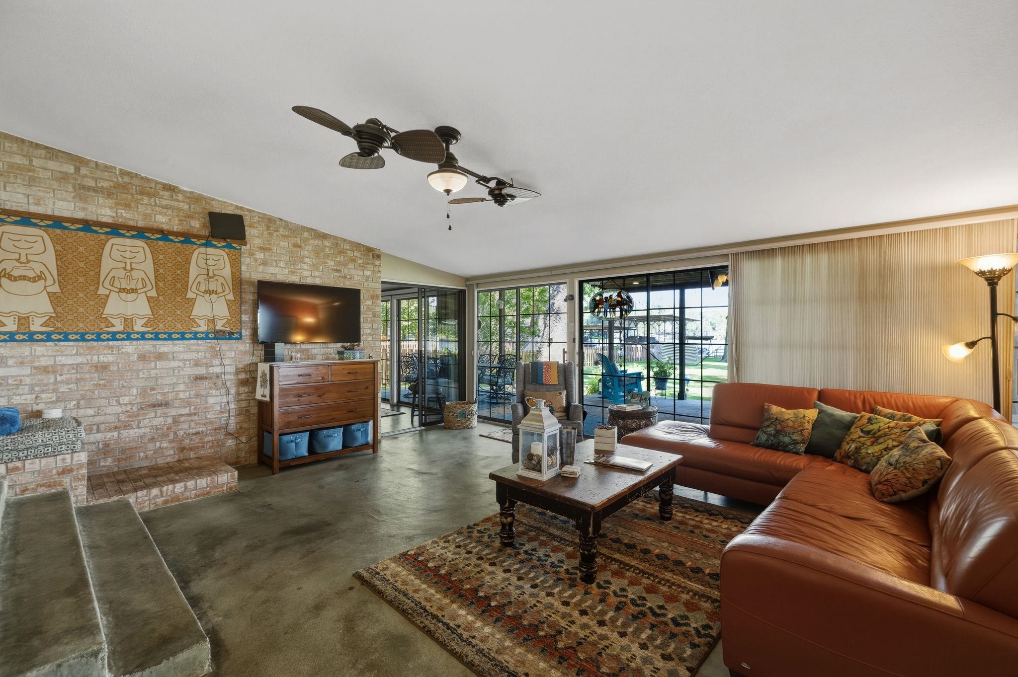 1435 East Zipp Road New Braunfels, TX 78130 - Photo 22 of 43 a living room with fireplace furniture and a flat screen tv