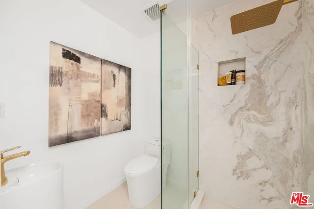 a bathroom with a shower and a toilet