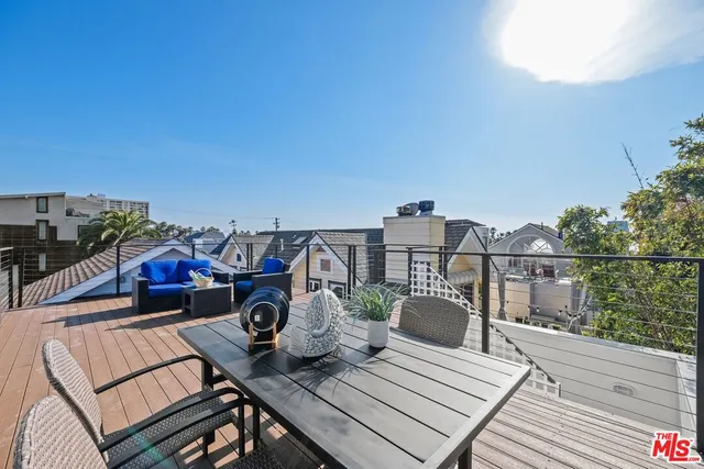 a view of a balcony with two chairs and a table
