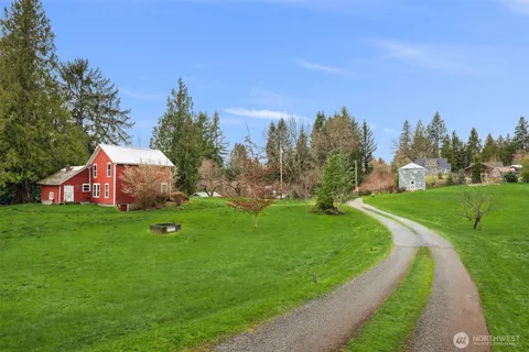 a front view of a house with a yard table and chairs