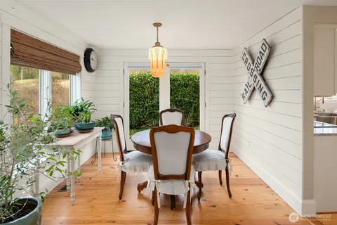 a living room with furniture a fireplace and a large window