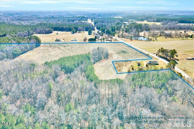 63 Rice Road Zebulon, NC 27597 - Photo 9 of 22 a view of a swimming pool and lake view