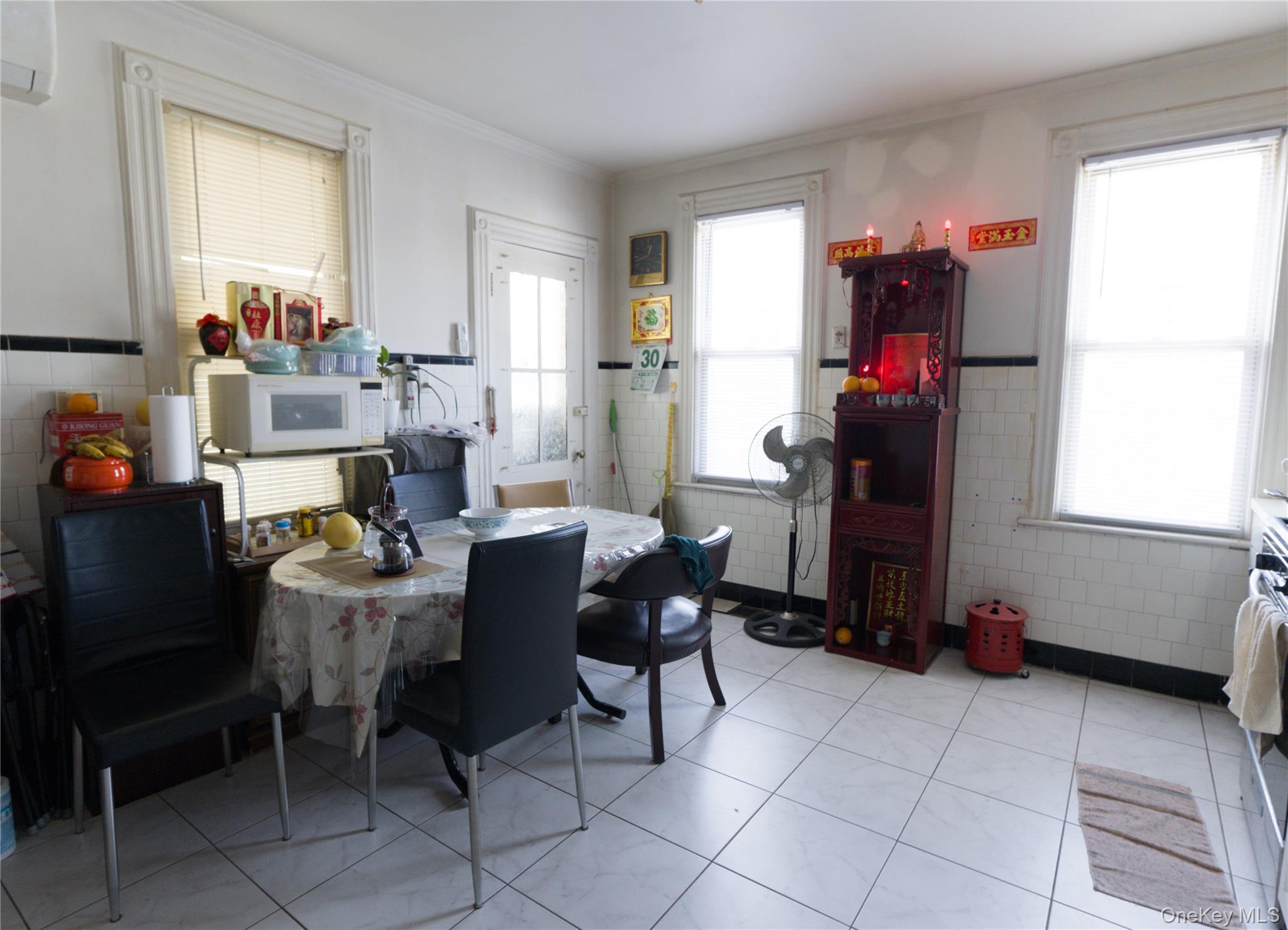 86-24 79th Street Queens, NY 11421 - Photo 11 of 31 a dining room with furniture and a window