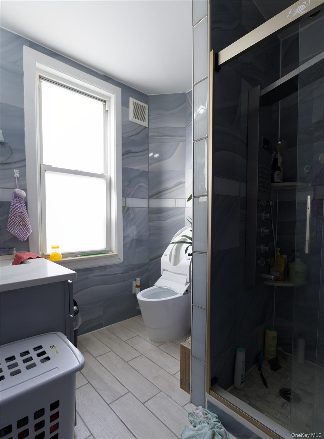 86-24 79th Street Queens, NY 11421 - Photo 13 of 31 a bathroom with a sink toilet and shower