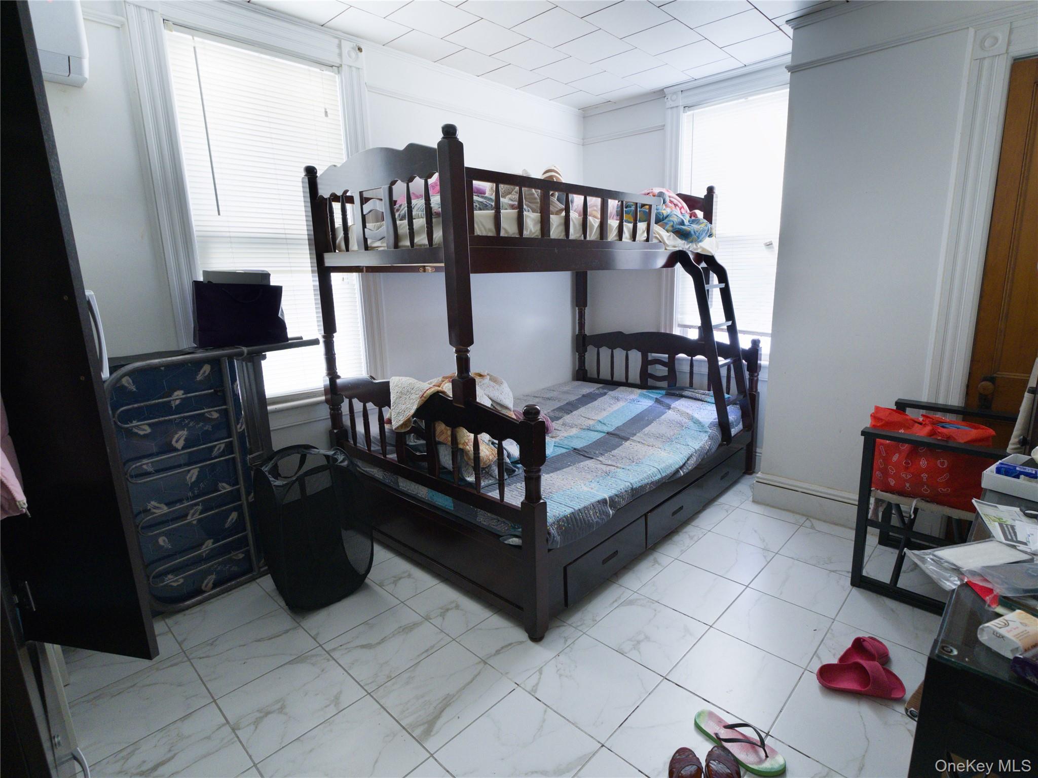 86-24 79th Street Queens, NY 11421 - Photo 14 of 31 a bedroom with furniture and a window