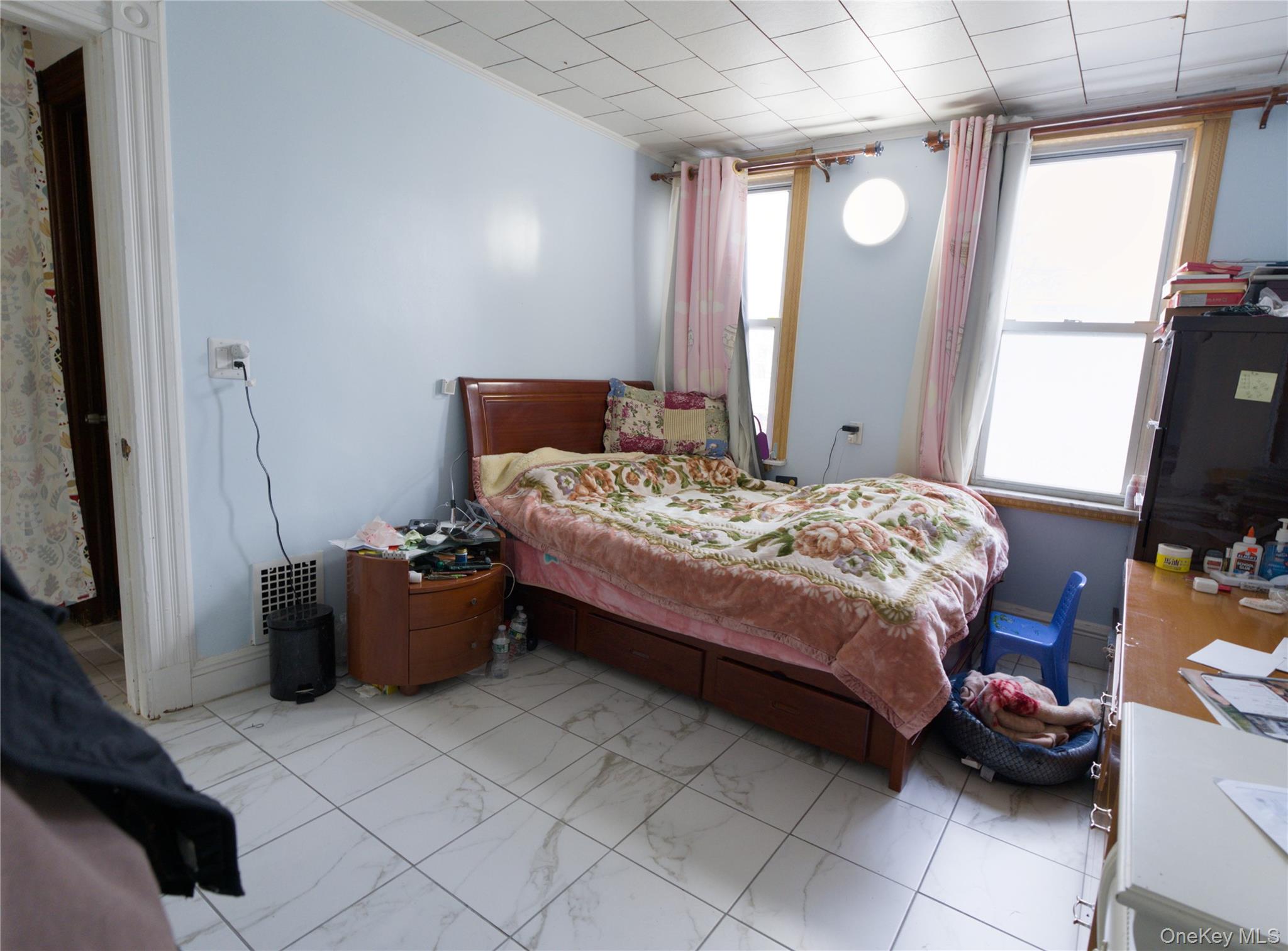 86-24 79th Street Queens, NY 11421 - Photo 15 of 31 a bedroom with a bed and a mirror
