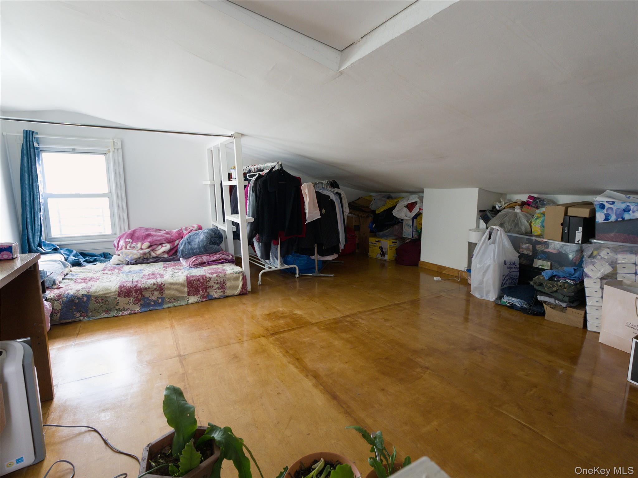 86-24 79th Street Queens, NY 11421 - Photo 17 of 31 a bed room with a bed and a chair