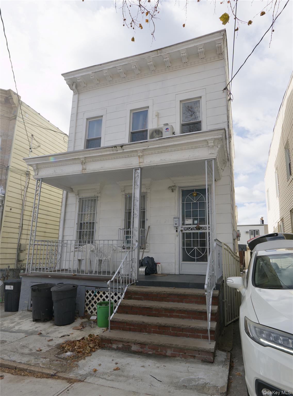 86-24 79th Street Queens, NY 11421 - Photo 2 of 31 a view of a house with a barbeque and wooden stairs