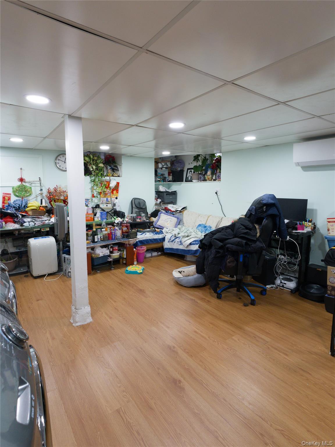 86-24 79th Street Queens, NY 11421 - Photo 21 of 31 a living room with lots of furniture and a chandelier