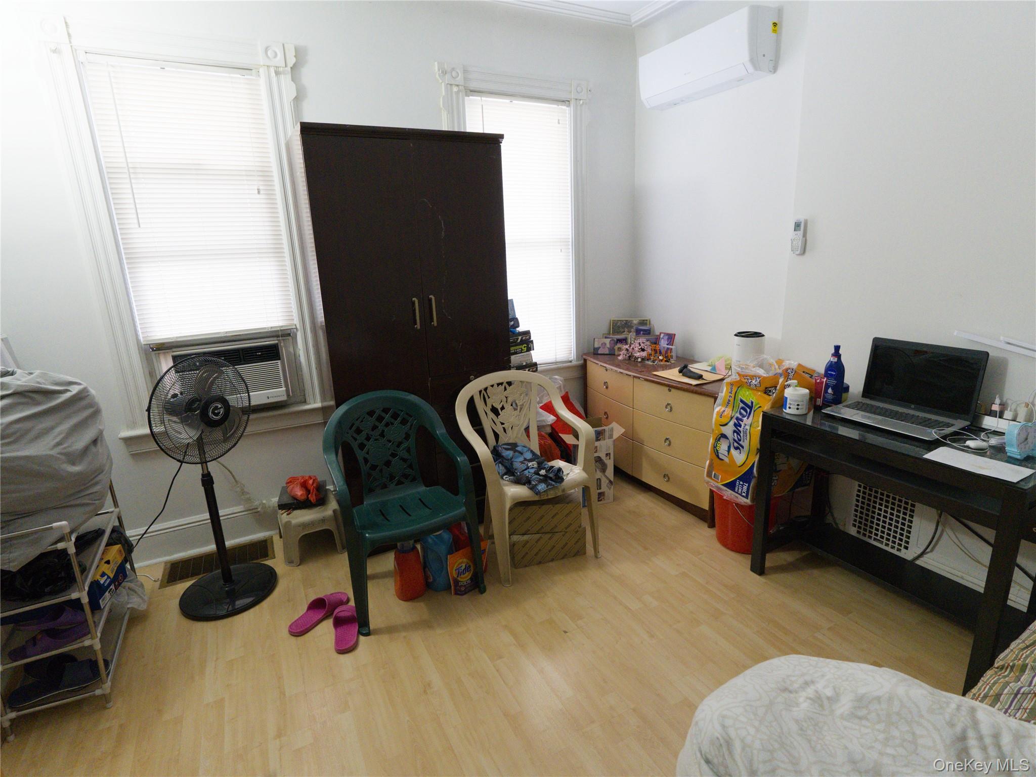 86-24 79th Street Queens, NY 11421 - Photo 6 of 31 a bedroom with bed and a window