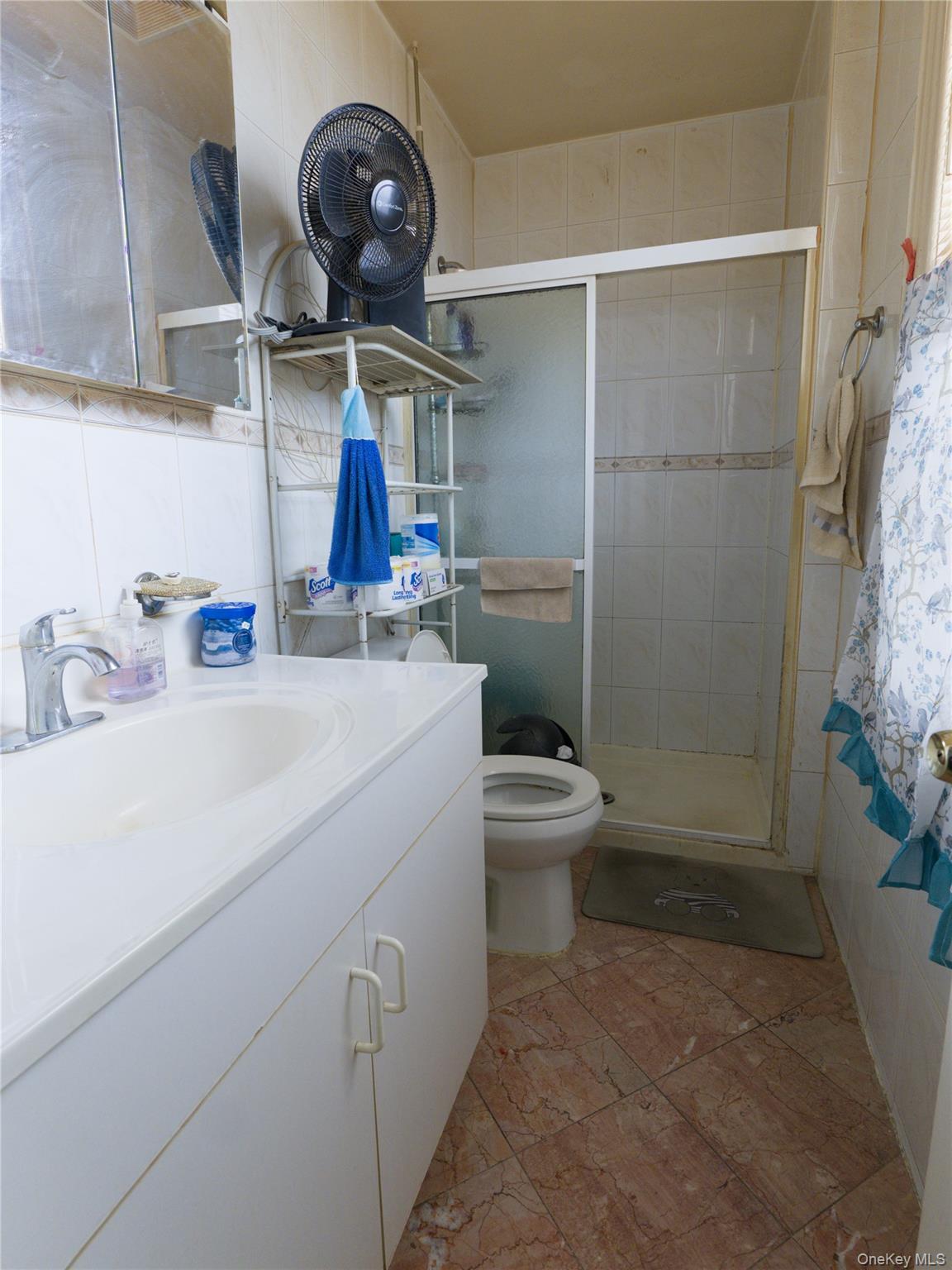 86-24 79th Street Queens, NY 11421 - Photo 7 of 31 a bathroom with a sink a toilet and shower