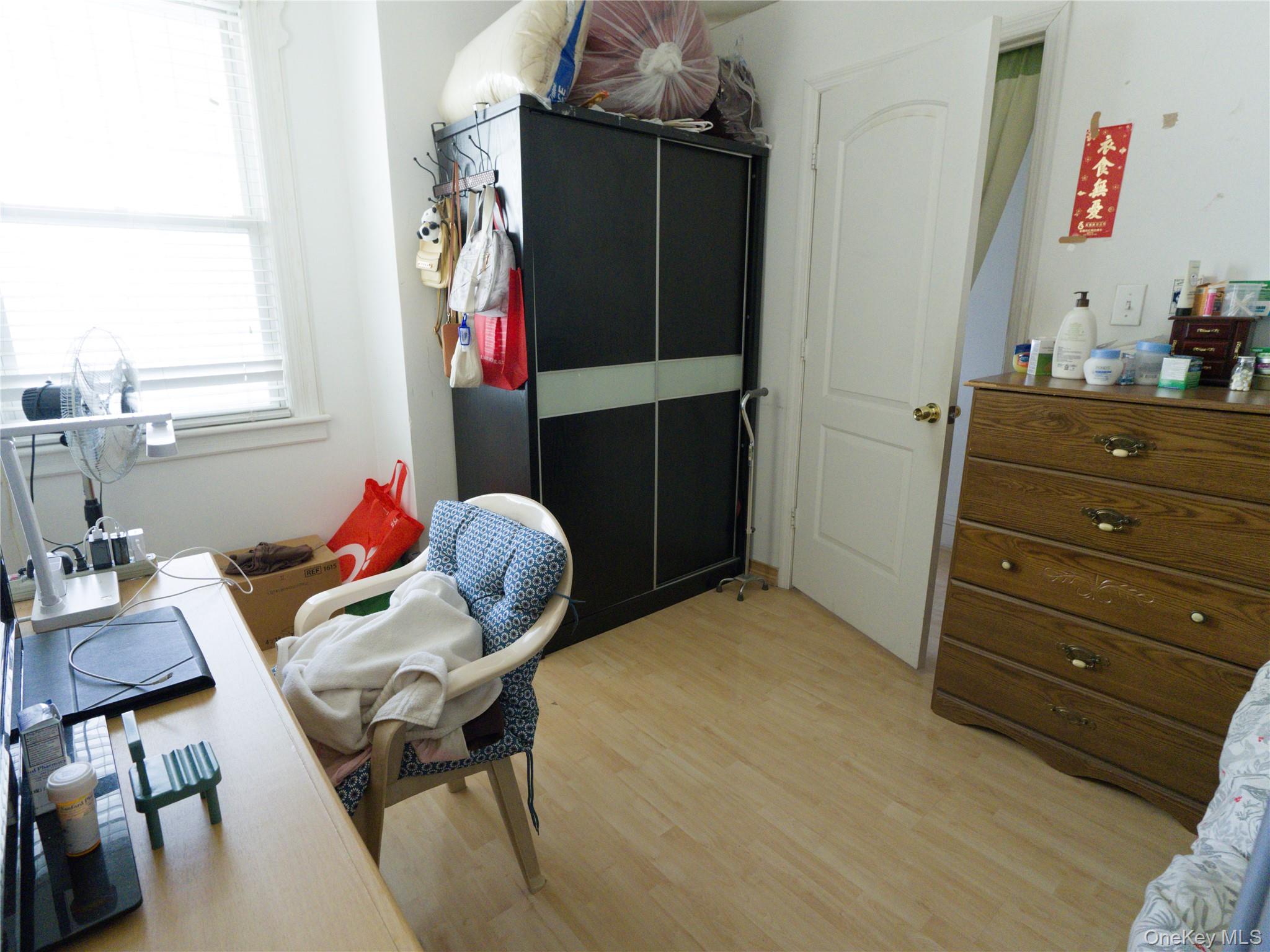 86-24 79th Street Queens, NY 11421 - Photo 9 of 31 a living room with furniture and a closet