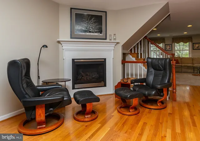 a living room with furniture a fireplace and wall