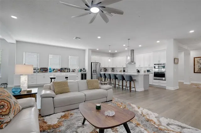 a living room with furniture and kitchen view