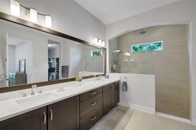 a bathroom with a sink mirror toilet and shower