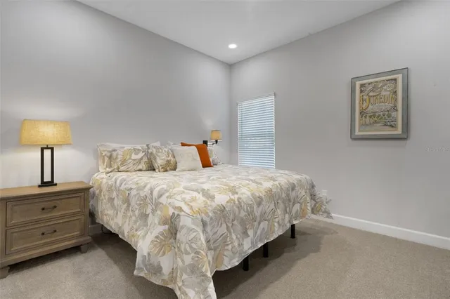 a living room with patio furniture and a floor to ceiling window