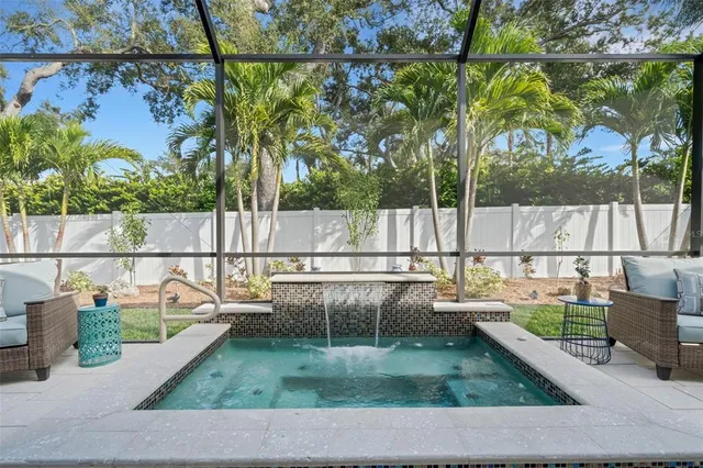an aerial view of a house with a yard and lake view