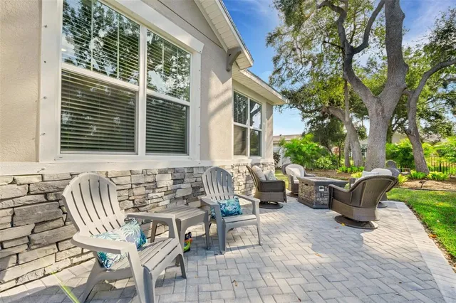 a view of a patio with table and chairs with wooden fence and plants