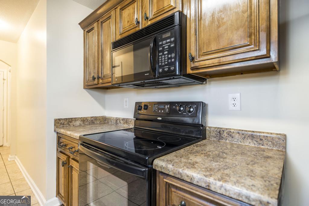 204 Chimney Rock Road Perry, GA 31069 - Photo 11 of 28 a kitchen with a stove microwave and sink