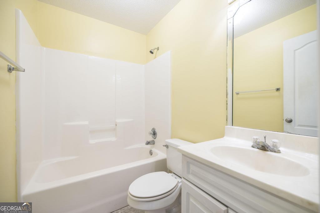 204 Chimney Rock Road Perry, GA 31069 - Photo 22 of 28 a bathroom with a bathtub shower sink vanity mirror and toilet