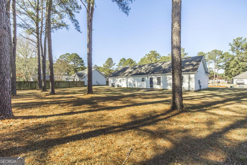 204 Chimney Rock Road Perry, GA 31069 - Photo 27 of 28 a view of a swimming pool with a yard