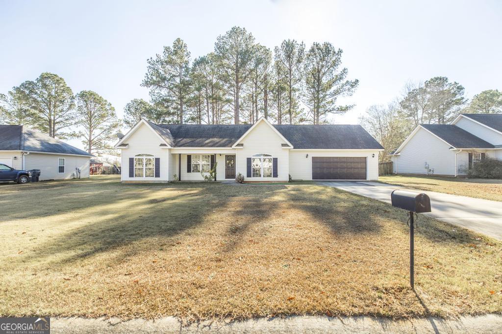 204 Chimney Rock Road Perry, GA 31069 - Photo 3 of 28 a front view of a house with a yard