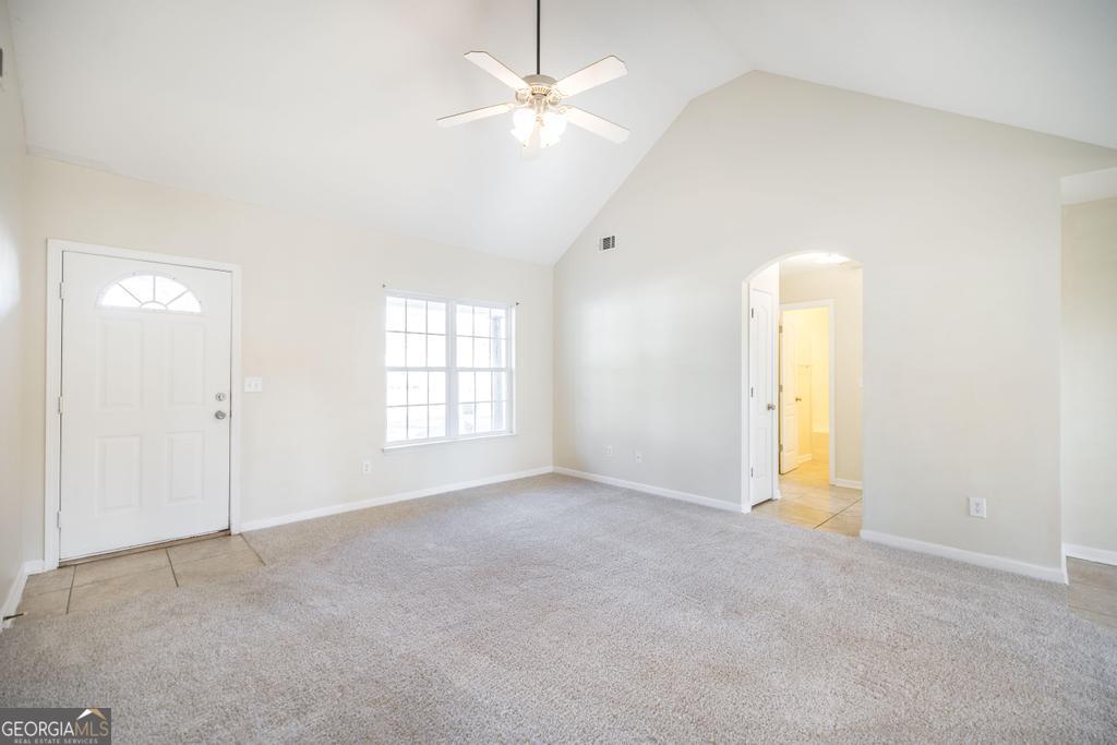 204 Chimney Rock Road Perry, GA 31069 - Photo 7 of 28 an empty room with a window and a ceiling fan