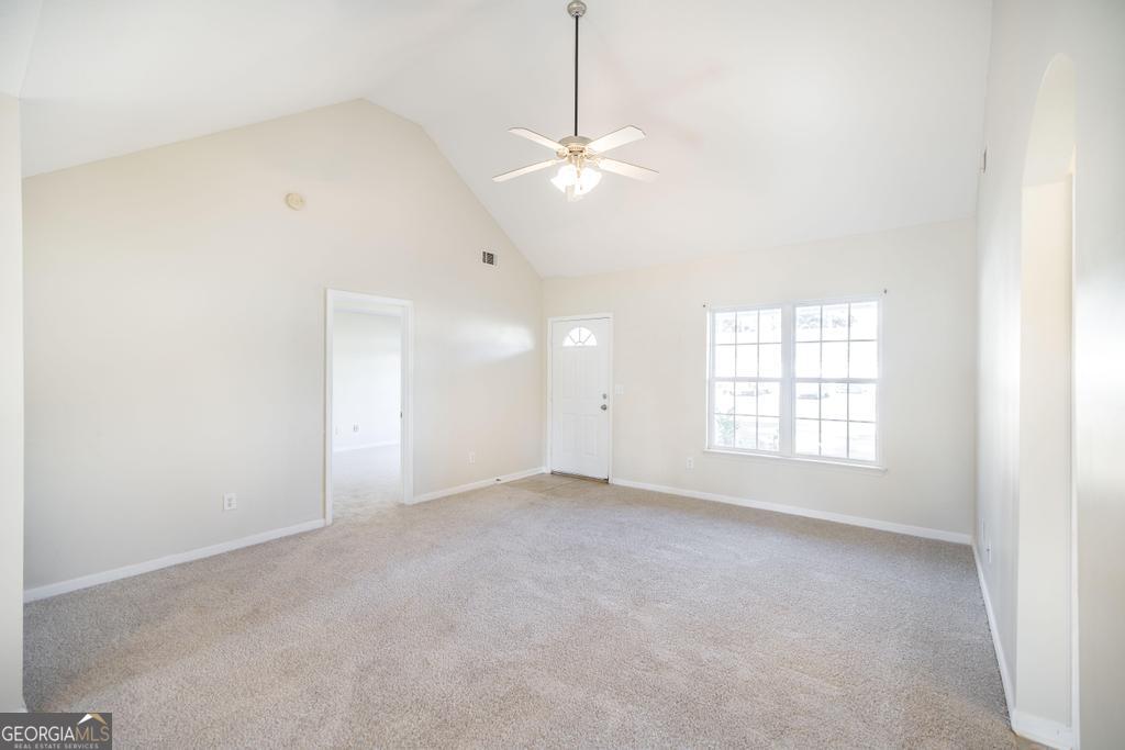 204 Chimney Rock Road Perry, GA 31069 - Photo 8 of 28 an empty room with windows and ceiling fan