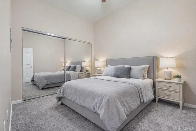 a bedroom with a bed and a night stand