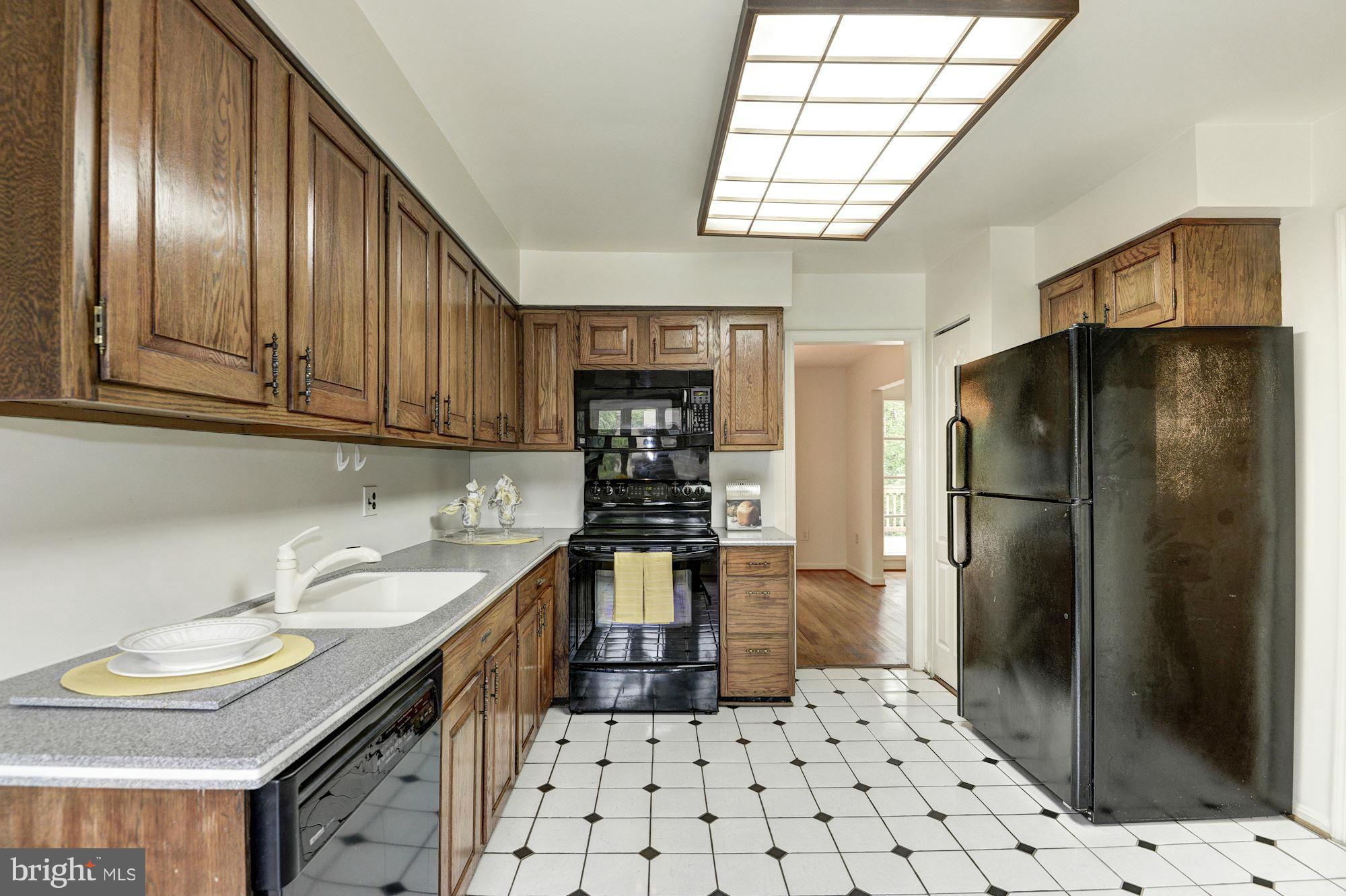 1305 Forestwood Drive McLean, VA 22101 - Photo 11 of 30 a kitchen with stainless steel appliances granite countertop a refrigerator a sink a stove and cabinets