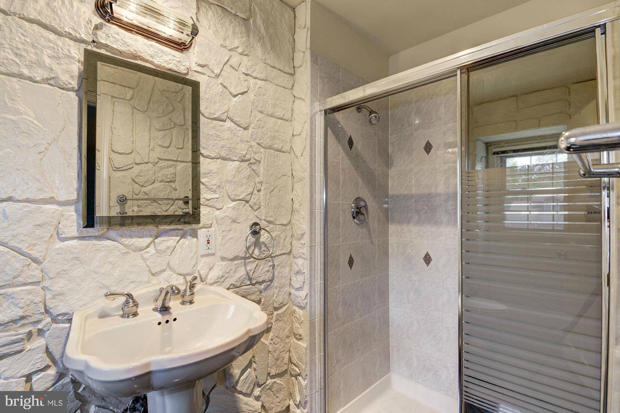 1305 Forestwood Drive McLean, VA 22101 - Photo 15 of 30 a bathroom with a sink shower and a mirror