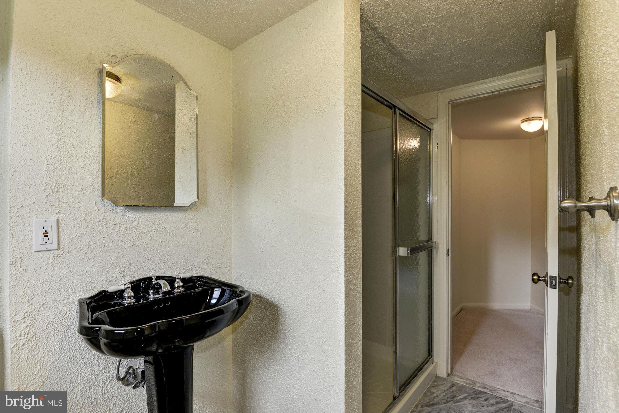 1305 Forestwood Drive McLean, VA 22101 - Photo 25 of 30 a bathroom with a sink and a mirror