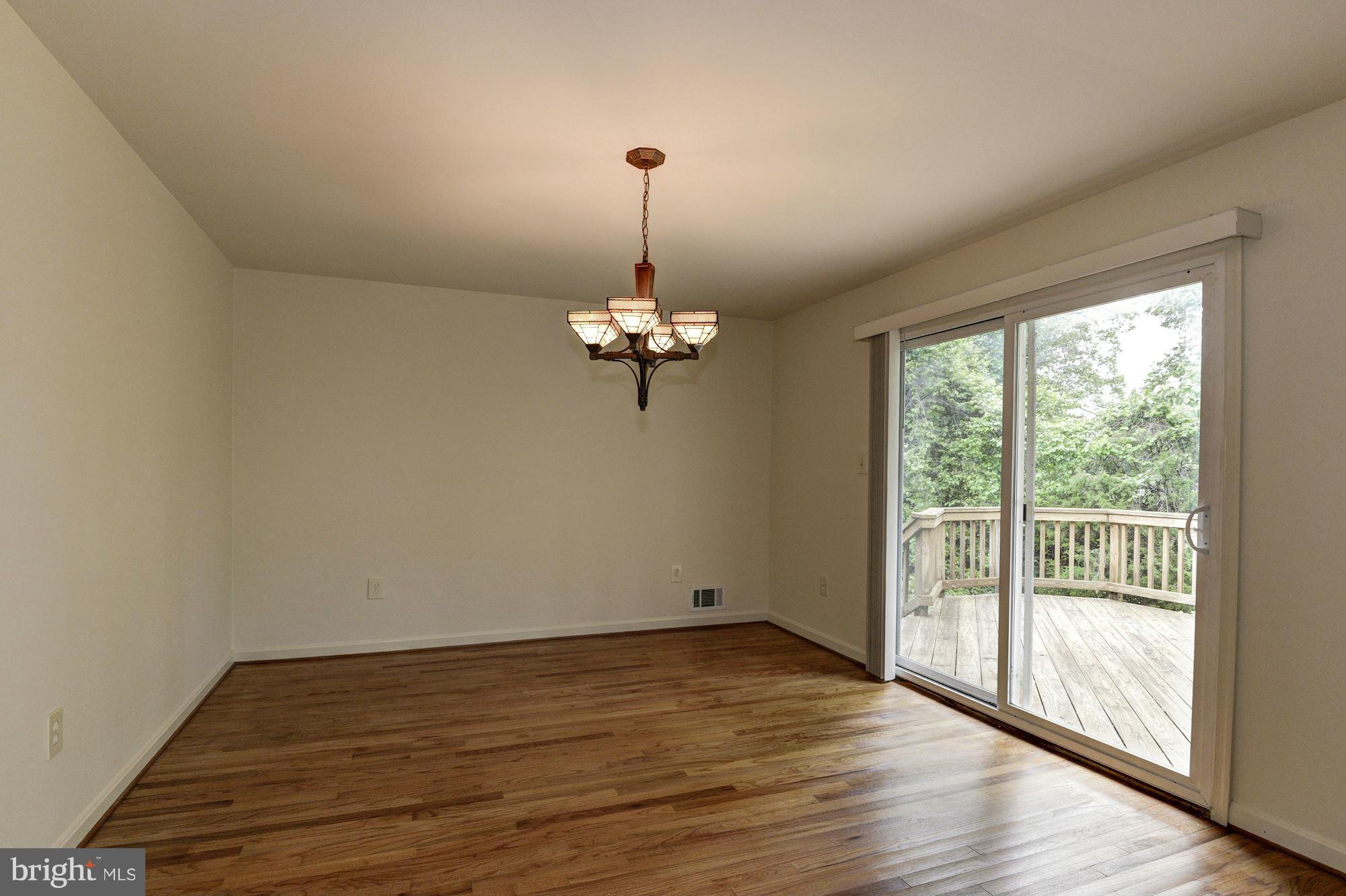 1305 Forestwood Drive McLean, VA 22101 - Photo 8 of 30 a view of a room with wooden floor chandelier and windows
