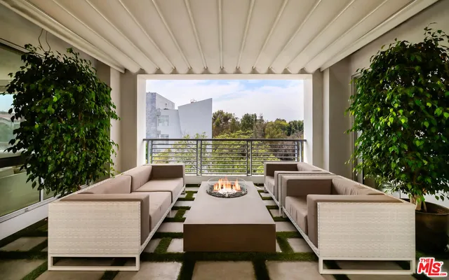 a view of a patio with couches table and chairs and potted plants