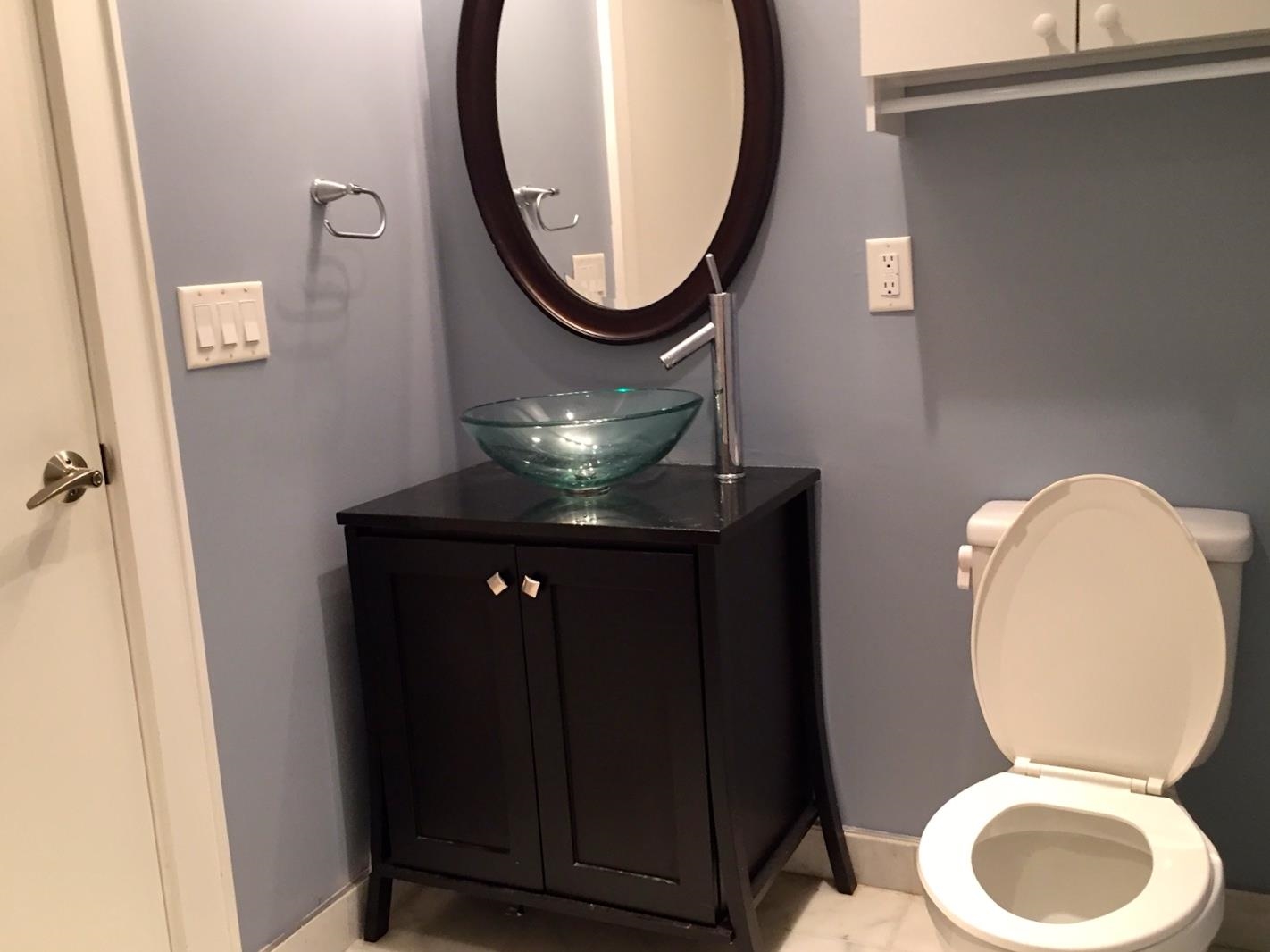 123 Jackson Street, Unit 2B Hoboken, NJ 07030 - Photo 11 of 13 a bathroom with a toilet mirror and vanity