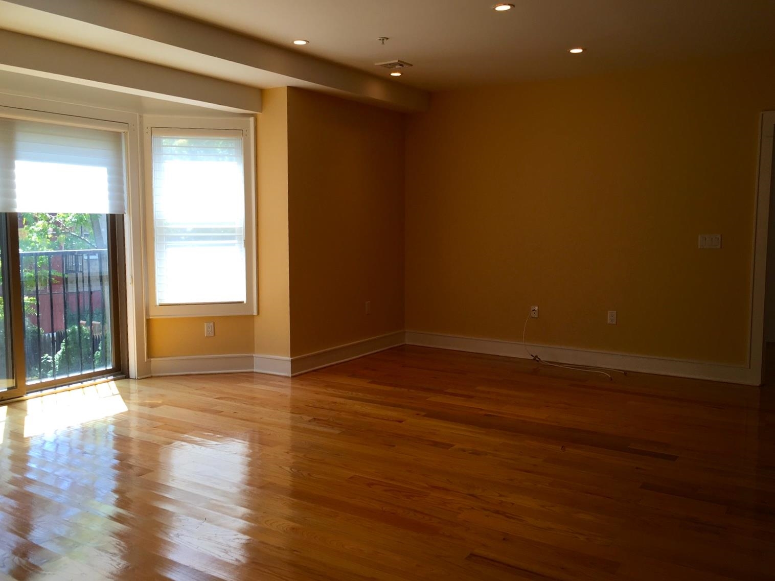 123 Jackson Street, Unit 2B Hoboken, NJ 07030 - Photo 2 of 13 a view of an empty room with wooden floor and a window