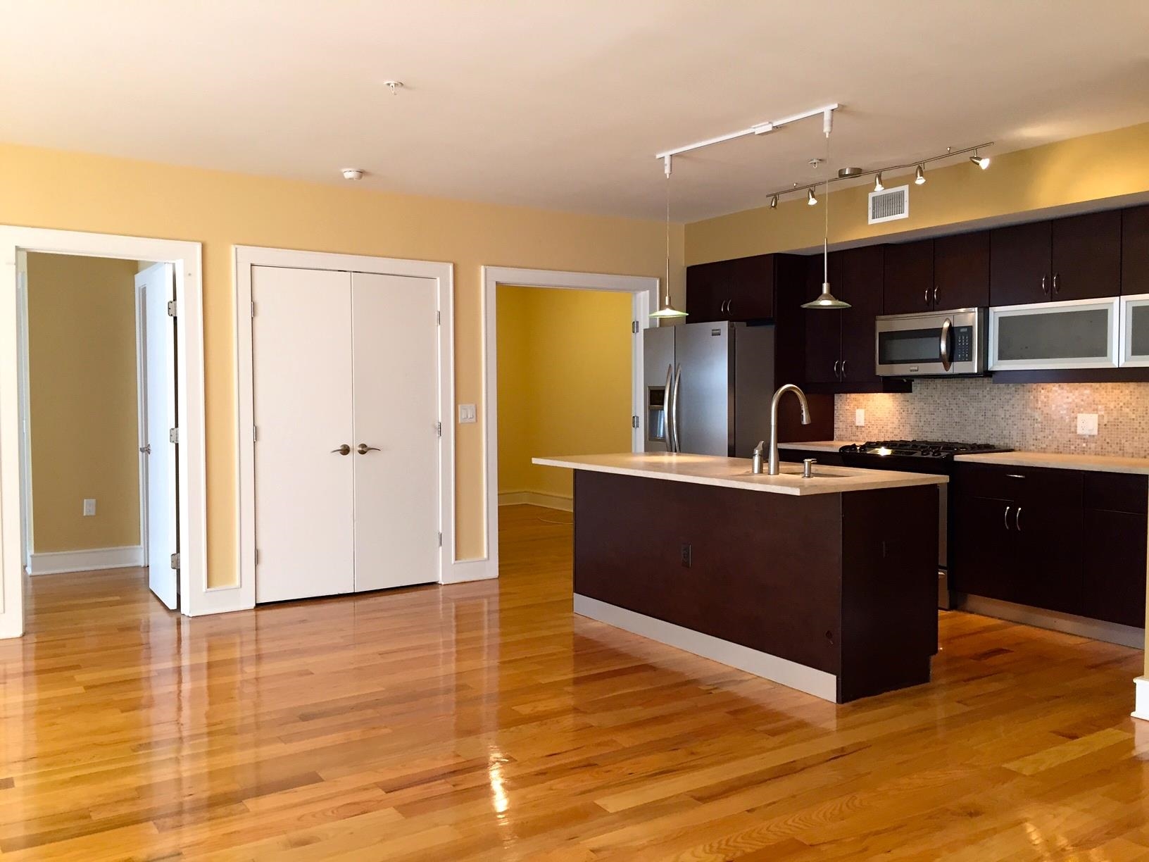 123 Jackson Street, Unit 2B Hoboken, NJ 07030 - Photo 4 of 13 a kitchen with stainless steel appliances granite countertop a refrigerator and a sink