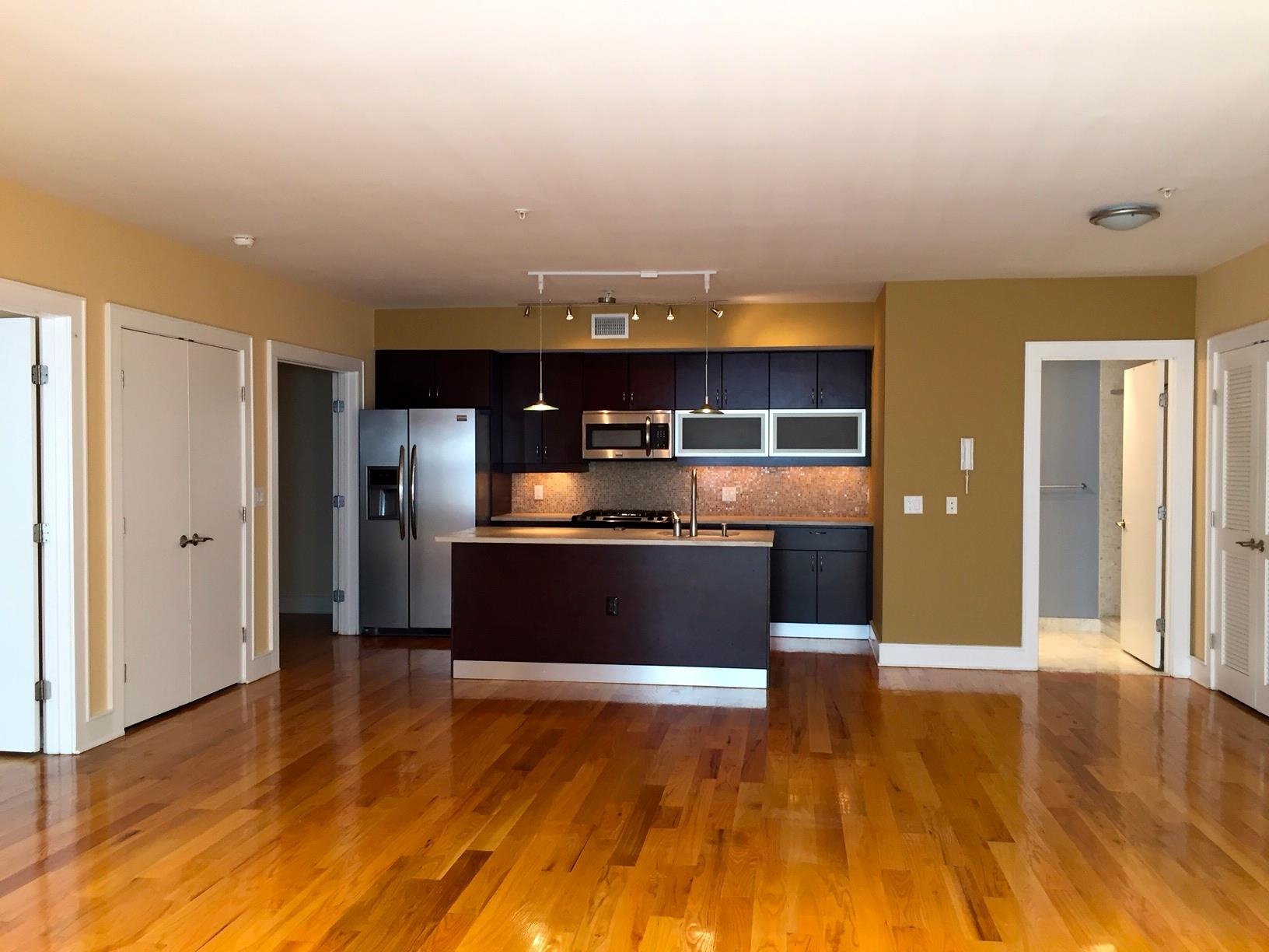 123 Jackson Street, Unit 2B Hoboken, NJ 07030 - Photo 5 of 13 a view of a kitchen with a refrigerator