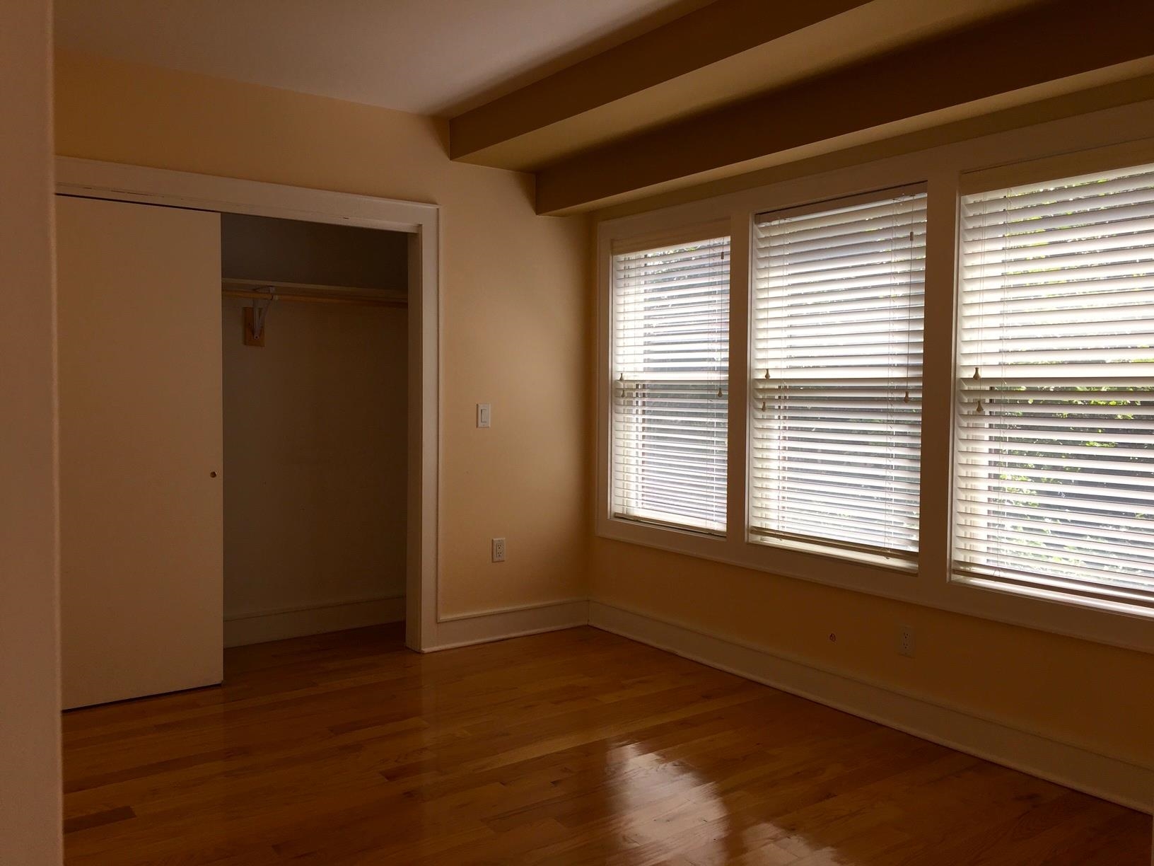 123 Jackson Street, Unit 2B Hoboken, NJ 07030 - Photo 6 of 13 a view of an empty room with wooden floor and a window