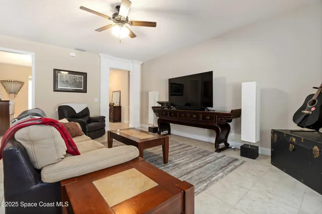 a living room with furniture and kitchen view