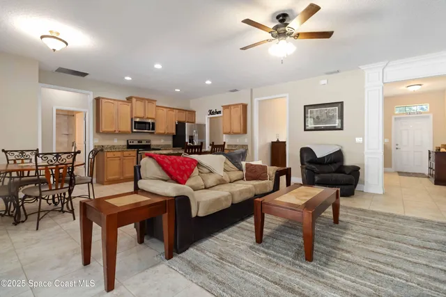 a kitchen with stainless steel appliances granite countertop a stove a sink a microwave a dining table and chairs