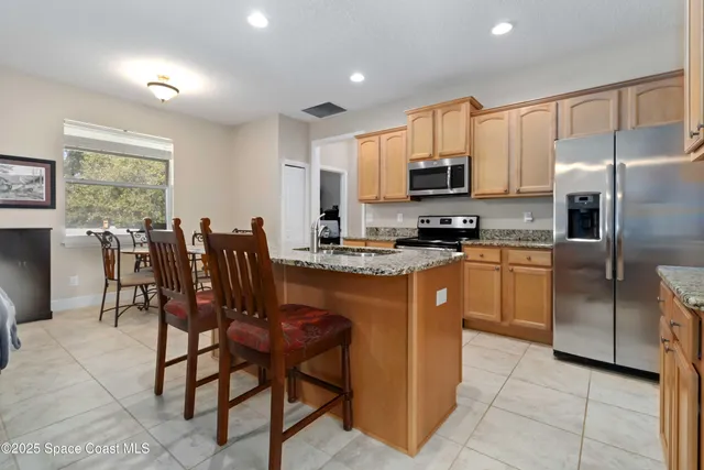 a kitchen with a sink appliances and cabinets