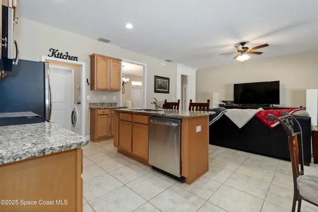 a spacious bedroom with a bed and a flat screen tv