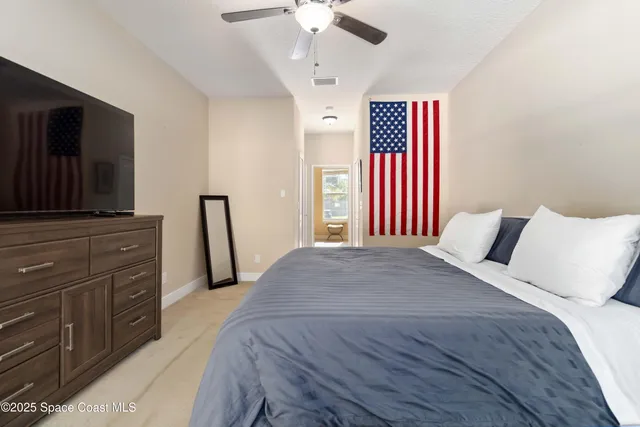 a spacious bathroom with a granite countertop sink a toilet a mirror and a window