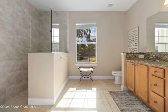 a bedroom with a bed and a refrigerator