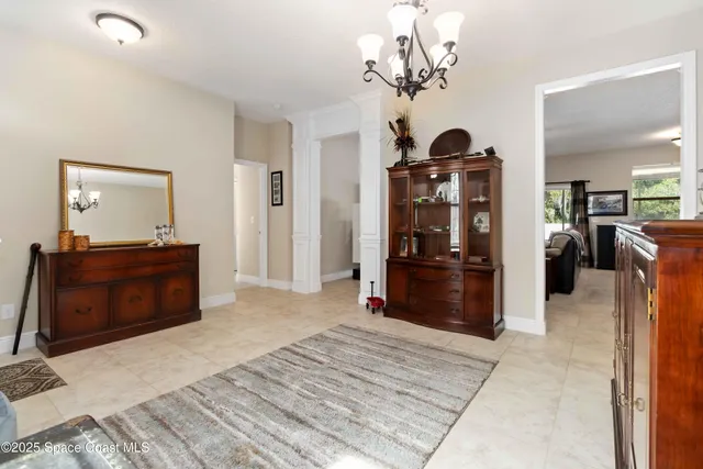 a spacious bedroom with a bed and dresser with mirror