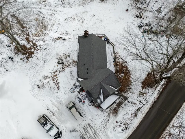 a view of a backyard with wooden fence and large trees